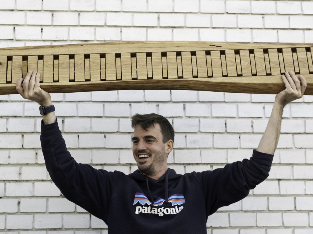 Live edge oak coat rack held high above head